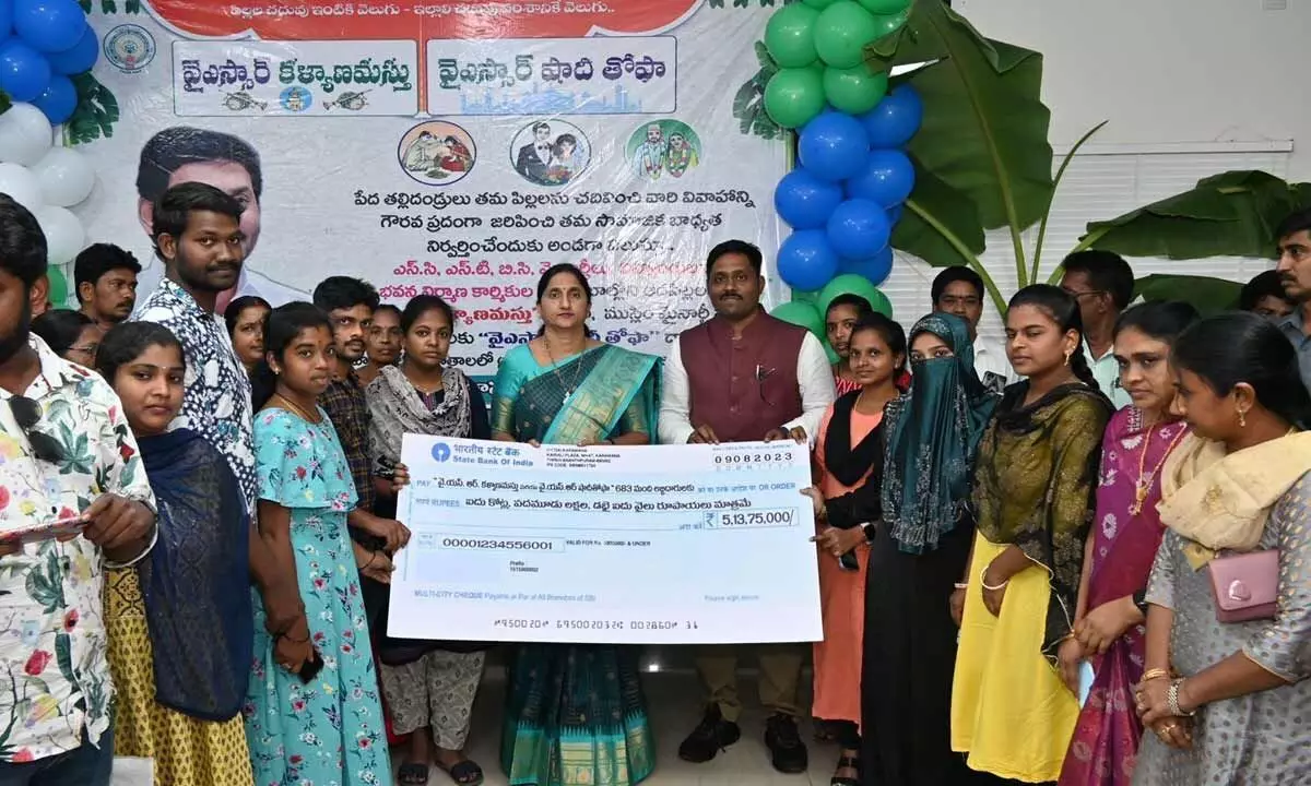 Collector Madhavi Latha and Joint Collector N Tej Bharat presenting a cheque to beneficiaries of YSR Kalyanamasthu and Shaadi Tohfa schemes on Wednesday