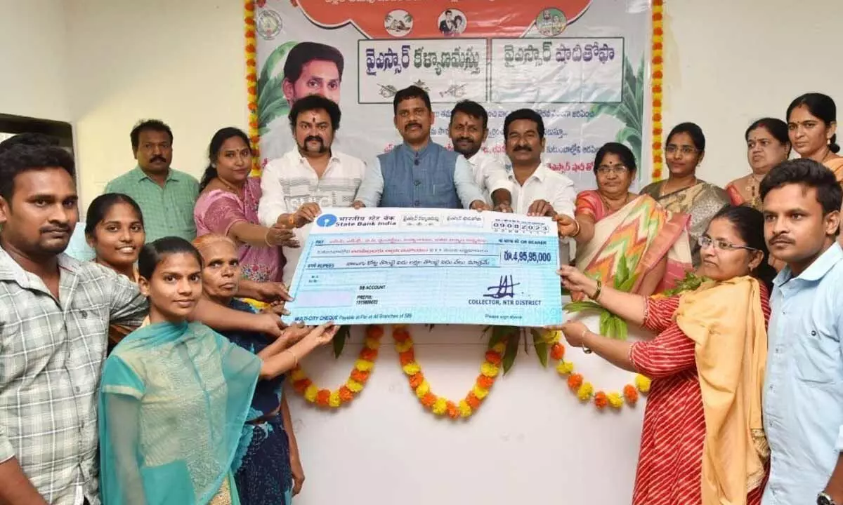 NTR District Collector S Dilli Rao handing over cheque to the beneficiaries in Vijayawada on Wednesday