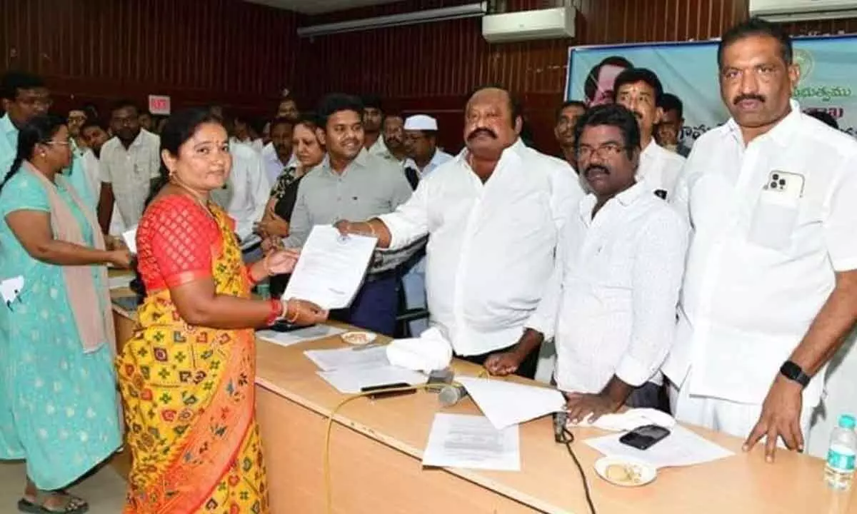 Minister G Kamalakar distributing appointment orders to VRAs as government employees in Karimnagar on Thursday