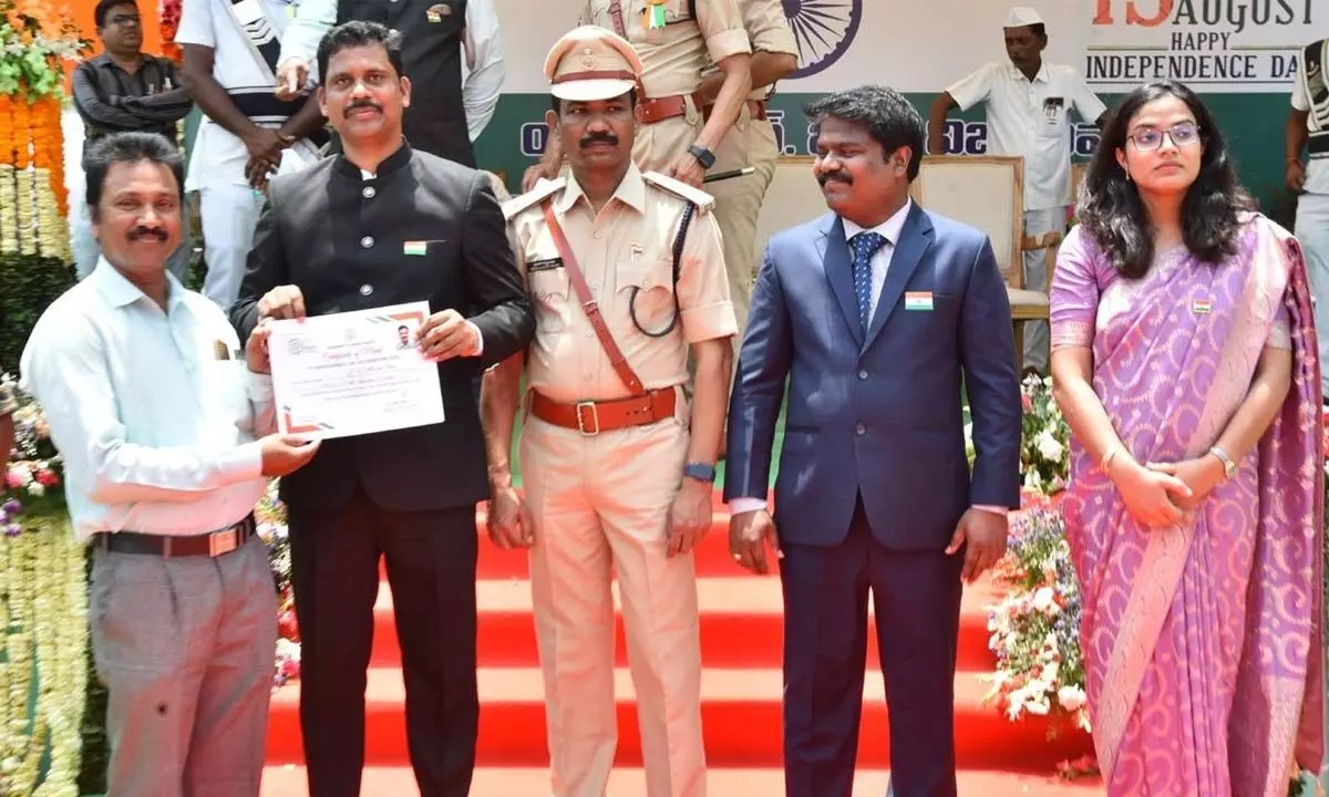 NTR District Collector S Dilli Rao distributing merit certificates to the best employees in Vijayawada on Sunday. DCP Moka Sathibabu, Sub-Collector Adithi Singh, Joint Collector Sampath Kumar are also present