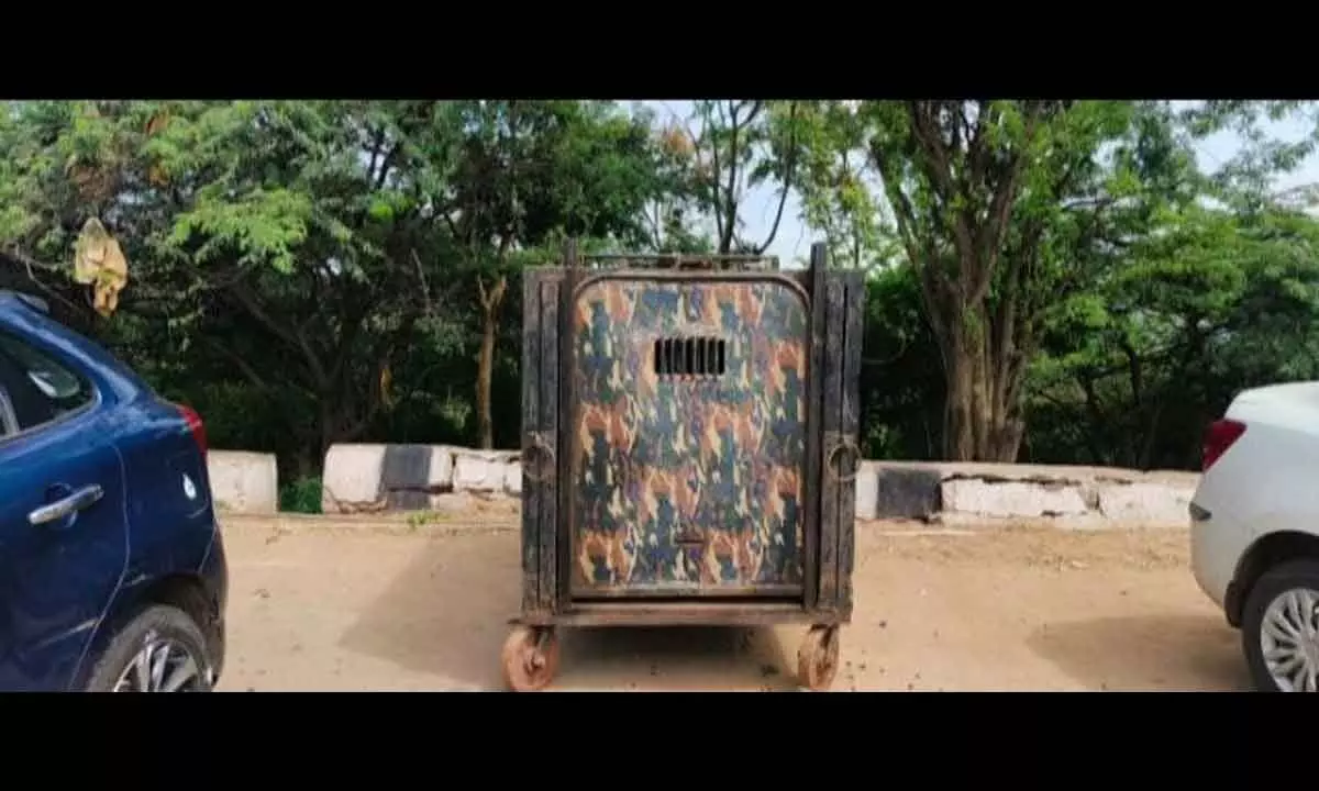 The cage set up by the forest department officials to trap a bear that was located at Sikhareshwaram near Srisaialm on Wednesday