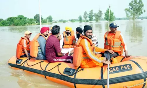 Riding boat, Punjab CM visits flood-hit areas