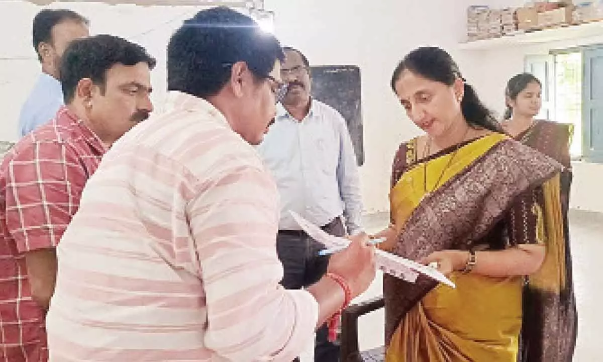 East Godavari Collector K Madhavi Latha verifying the voters’ list at the ZP High School at Palla Kadiyam village near Rajanagaram in East Godavari district during the panchayat bypolls on Saturday