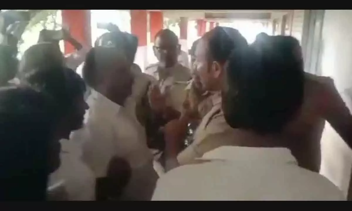 TDP cadres arguing with the police personnel demanding recounting of votes at Gangulapadu village in Peddakadabur mandal on Saturday