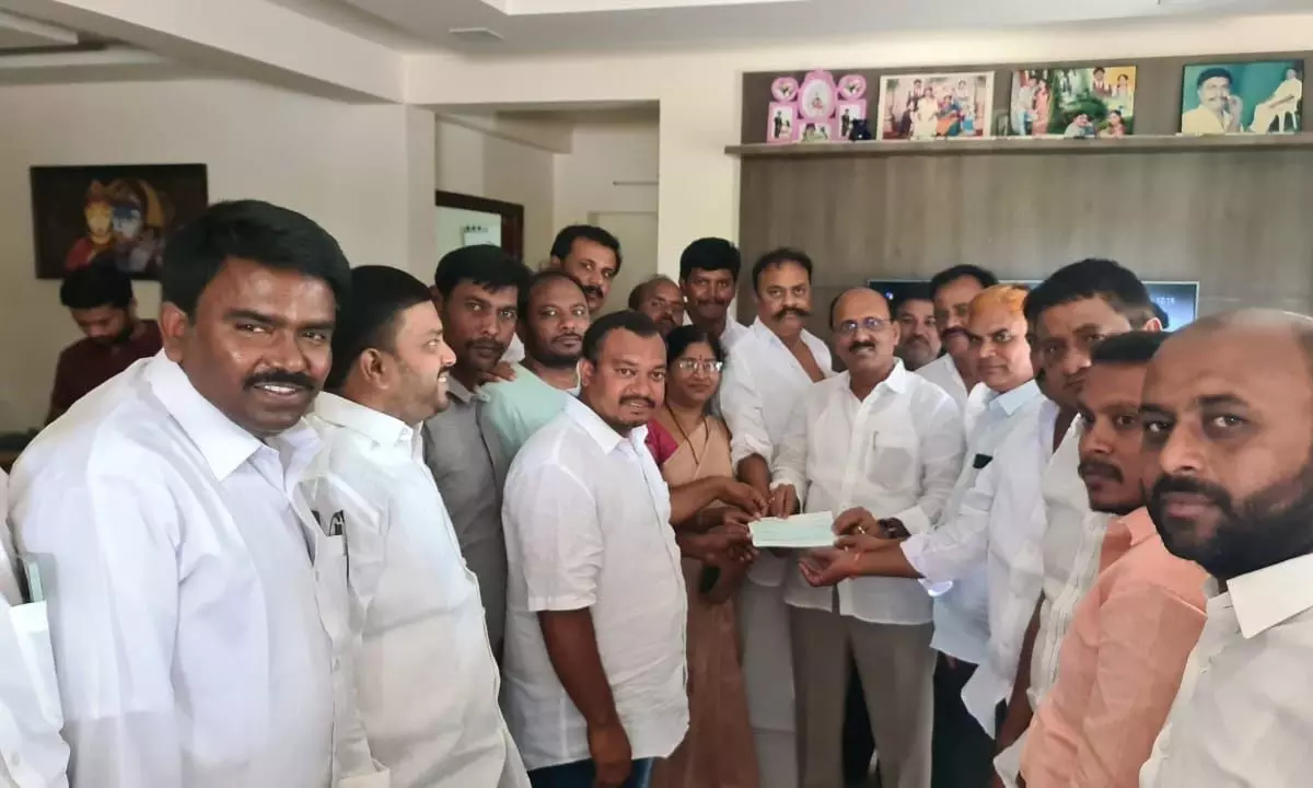 Rajampet MLA Meda Venkata Mallikarjuna Reddy handing over Rs 3 lakh cheque to Shaik Suleman, who is suffering with a heart ailment, at Besthapalle village in Sundupalle mandal on Sunday.