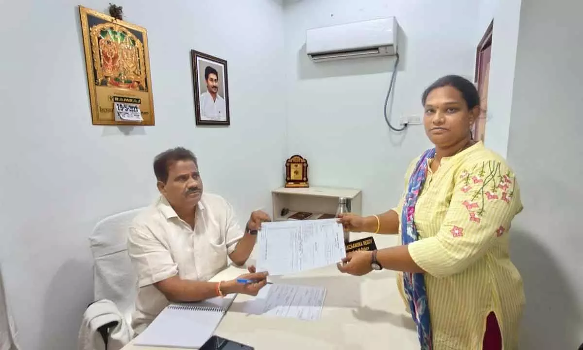 Cyber Lab CI Ramachandra Reddy handing over bank papers of tranfer of money to Sushmita, founder of Praja Pragathi Charitable Trust, in Tirupati on Monday