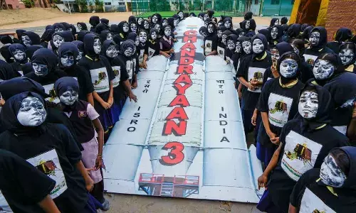 Students of Everwin School with their faces painted with moon celebrate the pre-soft landing of Chandrayaan-3, in Chennai on Tuesday