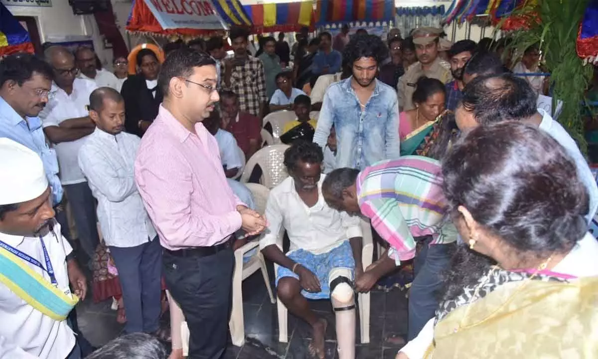 Principal district judge B Sai Kalyan Chakravarthy handing over artificial limbs to physically-challenged on Wednesday
