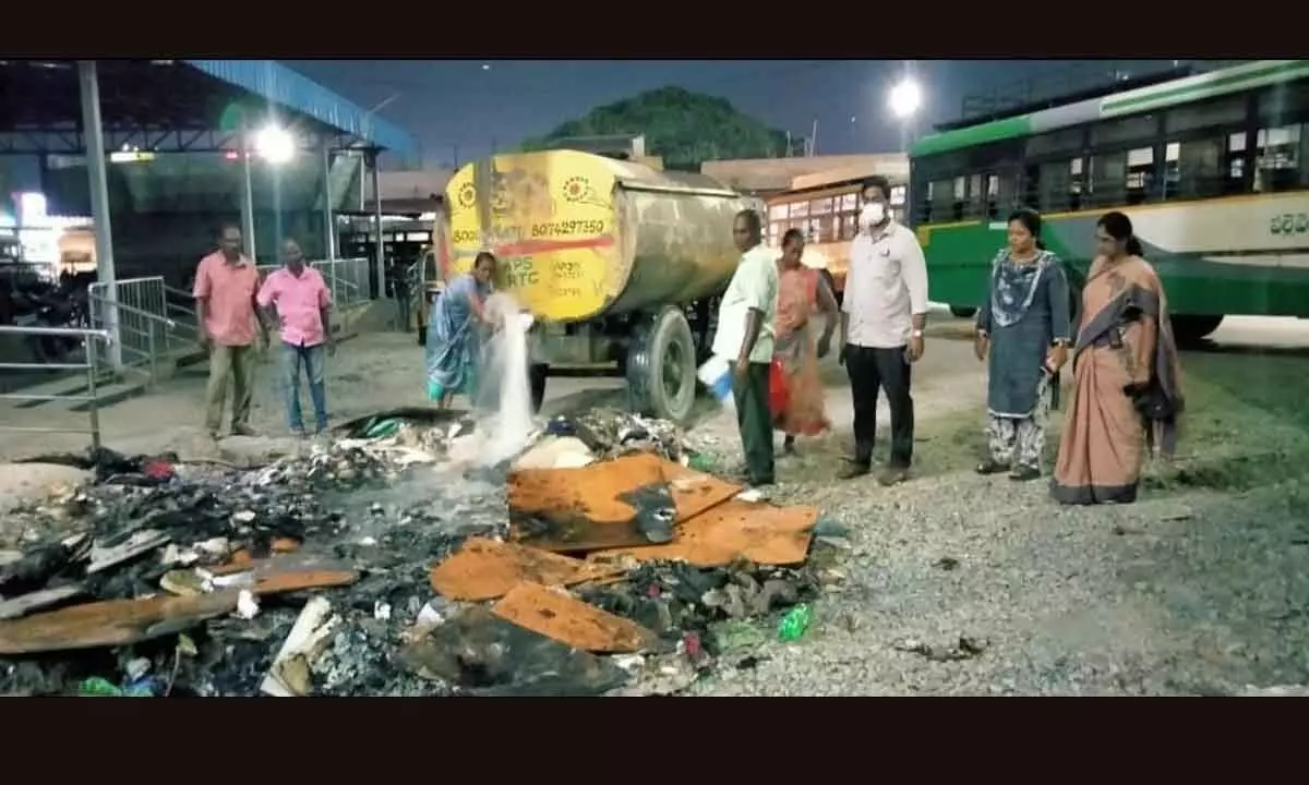 Municipal sanitary workers removing the garbage from RTC bus station in Tirupati on Wednesday