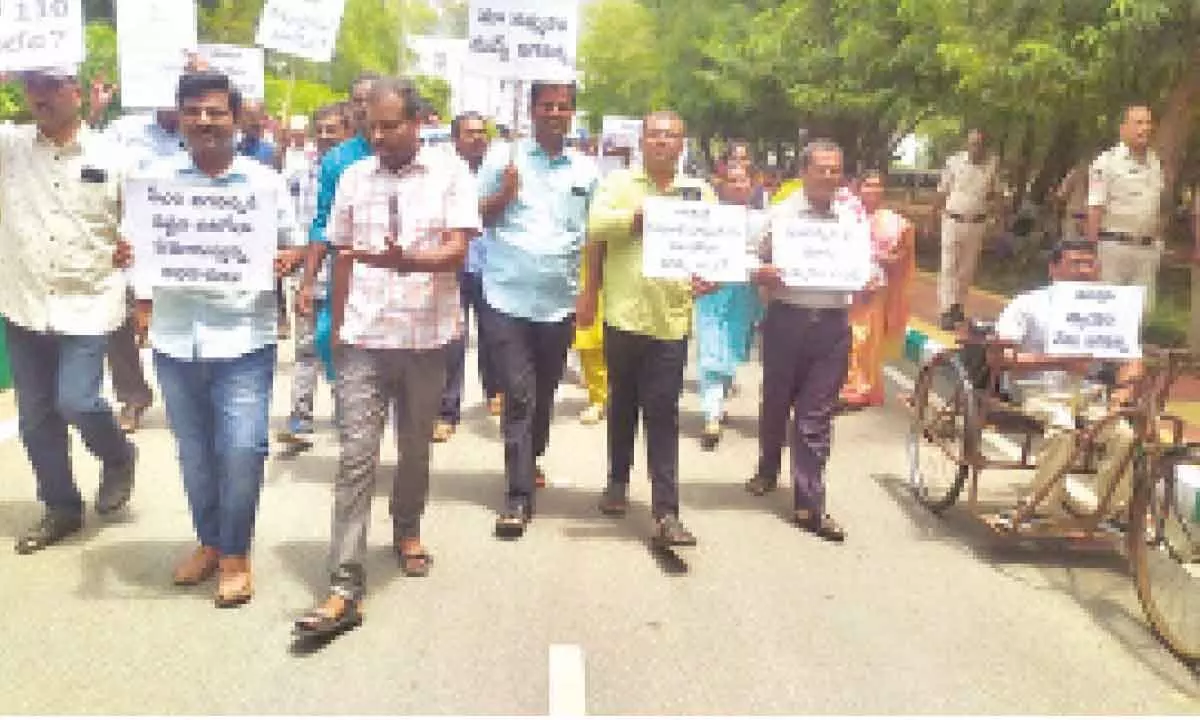 Academic consultants taking out a rally at SV University campus in Tirupati on Saturday.