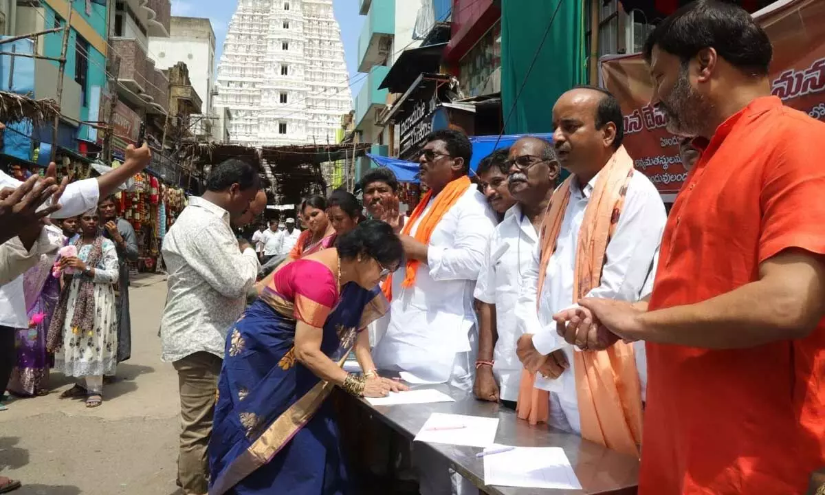 BJP activists launching the signature campaign at Govindaraja Swamy temple street in Tirupati on Monday
