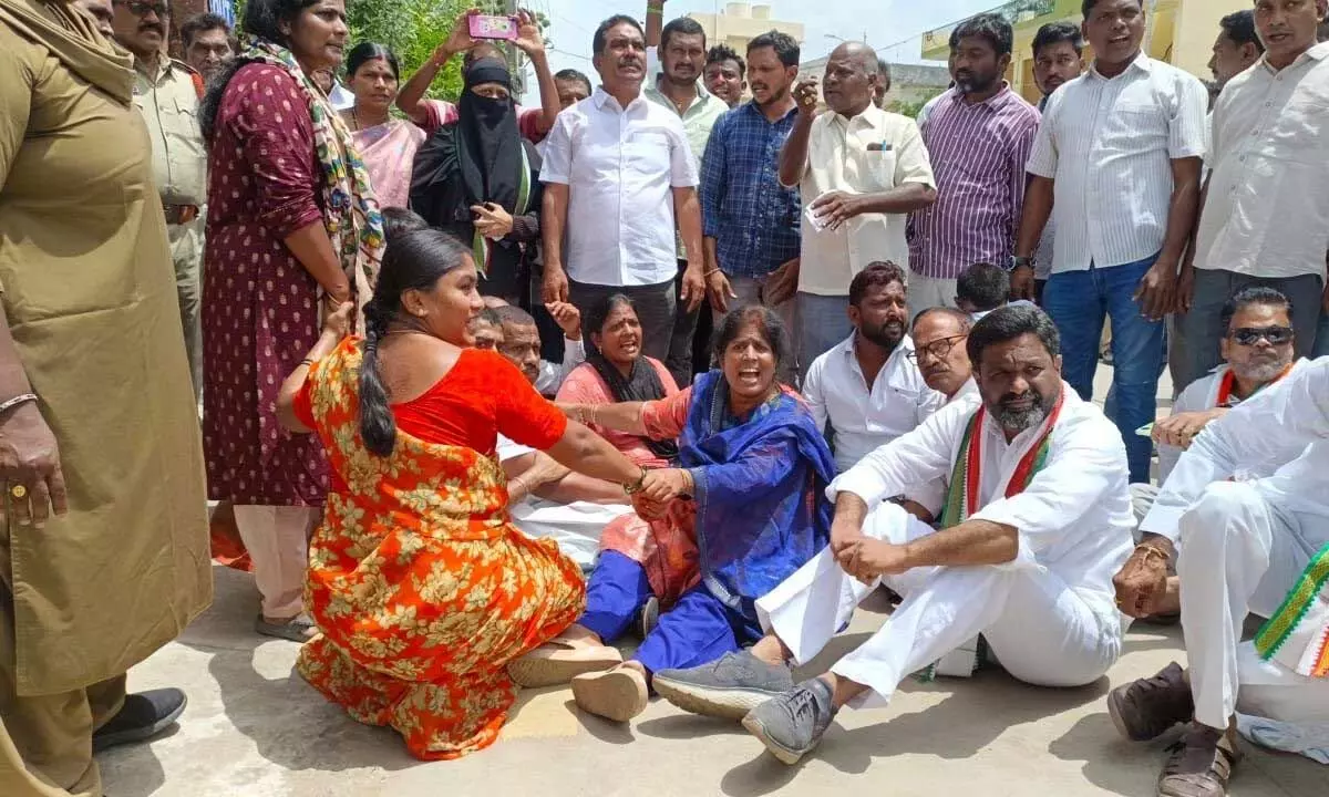 Congress city convener MD Javeed along with party leaders staging protest at Municipal Corporation  office in Khammam on Tuesday