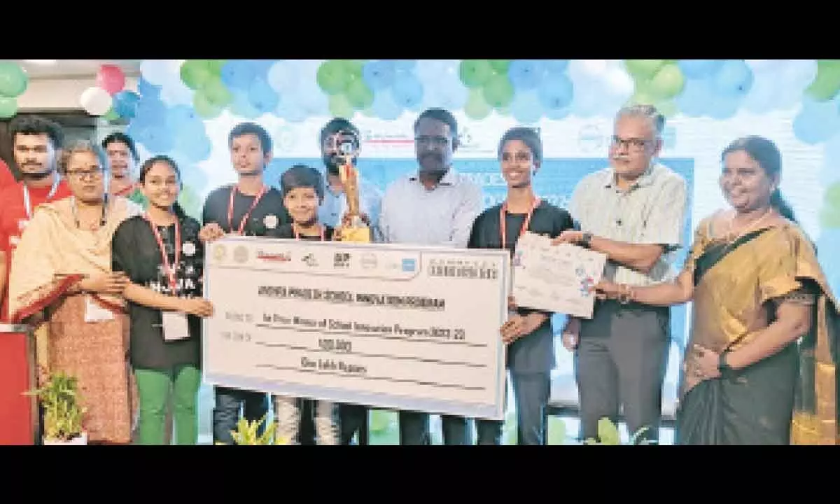 Commissioner of school education S Suresh Kumar presents the first prize to students in a programme in Vijayawada on Wednesday