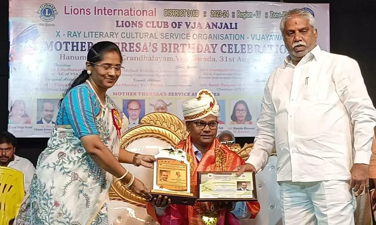 Dr (Maj) CS Rao receiving Mother Teresa award from Central MLA Malladi Vishnu and APIDC chairperson Bandi Punyaseela in Vijayawada on Thursday