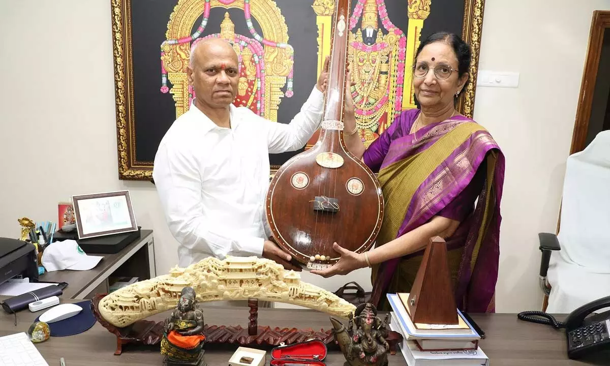 US-based devotee Vinjamuri Sandhya handing over traditional music instrument veena to TTD EO A V Dharma Reddy in Tirumala on Thursday