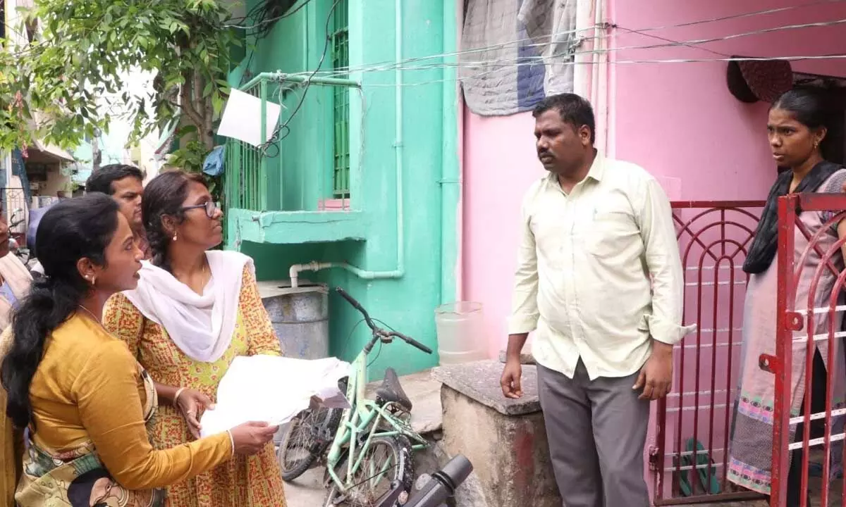 Municipal Commissioner D Haritha interacting with a resident during voters list verification at Vinayak Nagar in Tirupati on Thursday