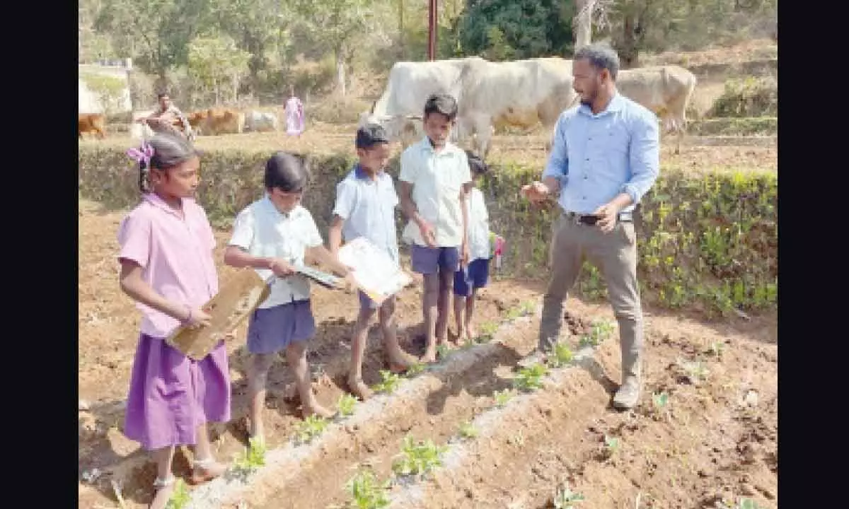 SGT Gamparai Venkata Ramana explaining farming techniques to students of MPPS at G Boddaputtu village in ASR district