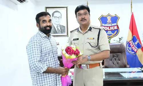 Errabelli Pradeep Rao Charitable Trust chairman Errabelli Vineeth Rao greets Commissioner of Police A V Ranganath at the release of job mela posters in Warangal on Saturday