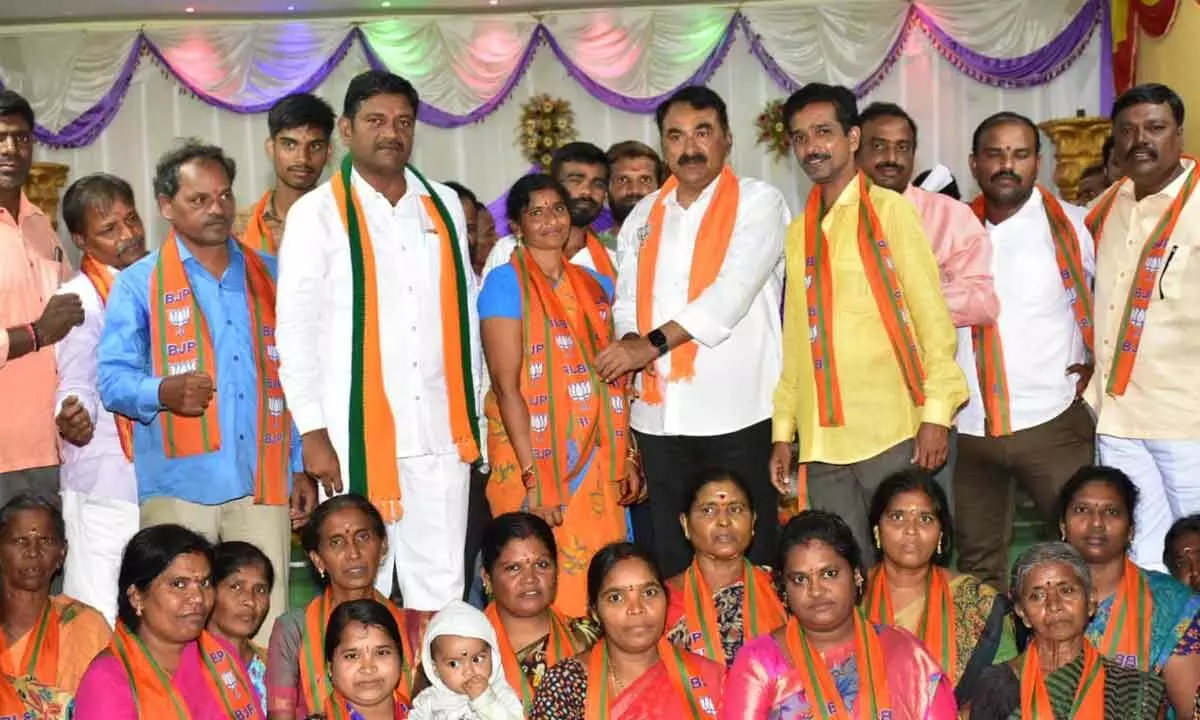 Warangal Urban Cooperative Bank Limited chairman and senior BJP leader Errabelli Pradeep Rao inviting a woman by offering party scarf in the 40th Division of GWMC in Warangal on Monday