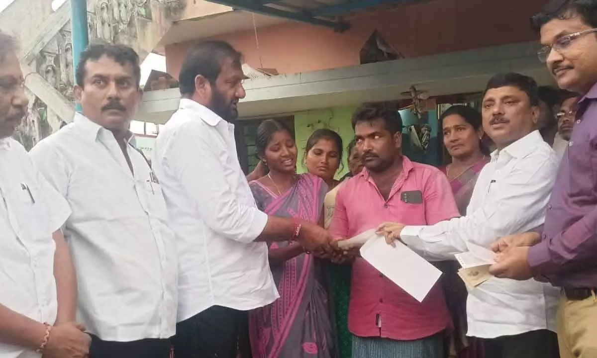 Kovur MLA N Prasanna Kumar Reddy hands over ex gratia cheques to the parents of Lakshita at Pothireddypalem village on Monday
