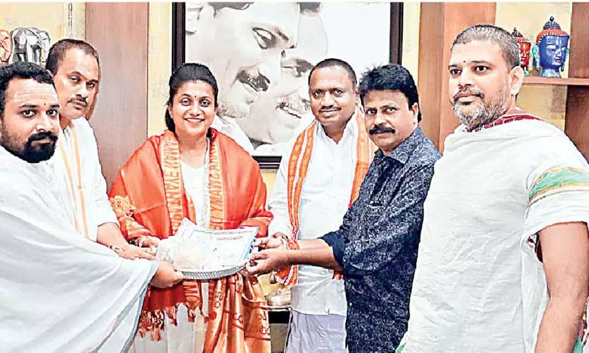 Kanipakam Temple Trust Board Chairman Mohan Reddy, Executive Officer Venkatesh extending an invitation to Tourism Minister R K Roja at Nagari on Wednesday