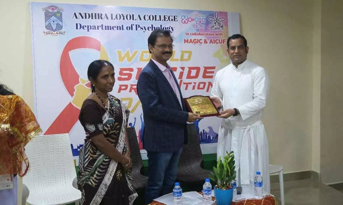 Psychiatrist Dr Ayodhya being poresented with a memento after he addressed a symposium  in connection with World Suicide Prevention Day at Andhra Loyola College in Vijayawada on Saturday