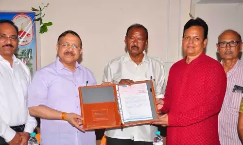 Central Bank of India MD and CEO M Venkat Rao handing over Rs 25 lakh cheque towards the donation under CSR to Sri Saraswati Sisumandir school committee secretary Hemanth (red shirt) in Tirupati on Saturday.