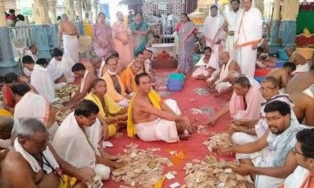 Employees of Sri Kanaka Mahalakshmi Devasthanam counting the Hundi offerings at the temple in Visakhapatnam on Monday