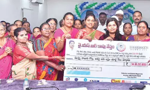Krishna Zilla Parishad Chairperson Uppala Harika and Joint Collector Dr Aparajitha Singh handing over specimen cheques to the beneficiaries under YSR Kapu Nestham scheme in Machilipatnam on Saturday