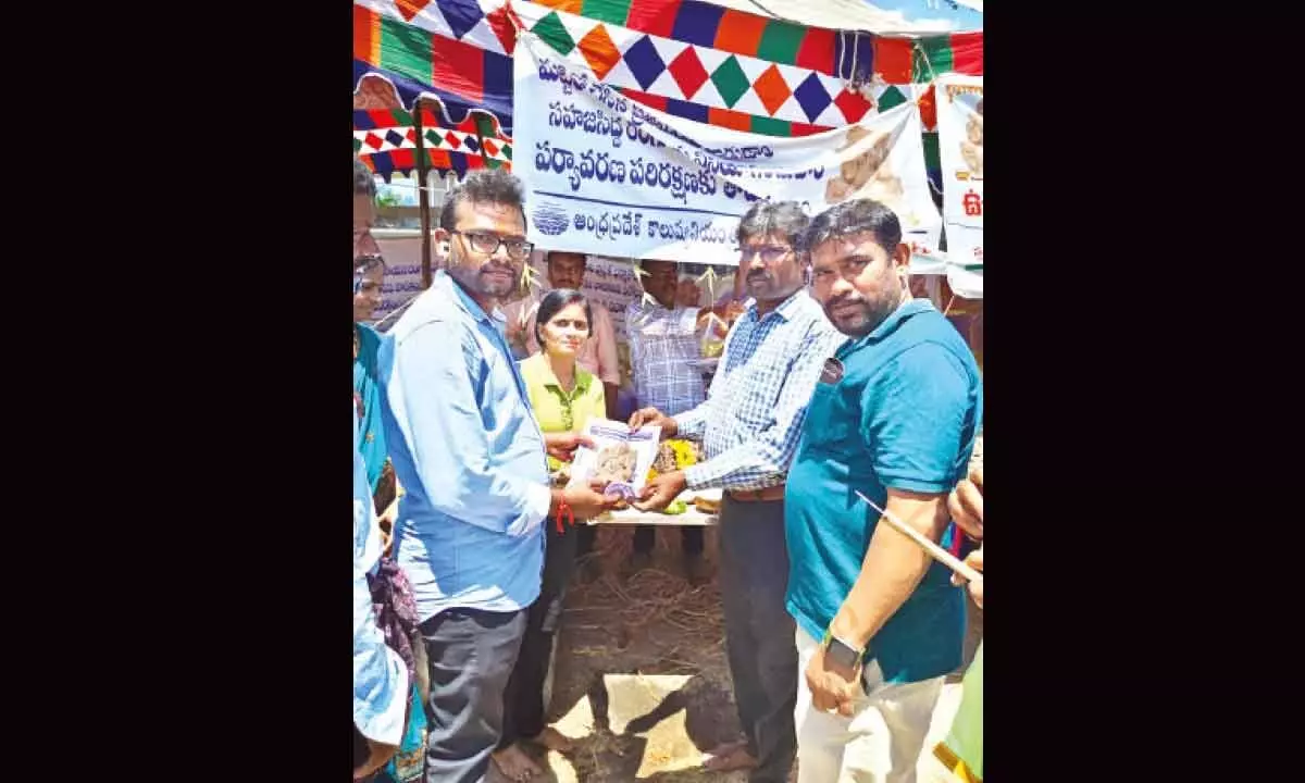 AP Pollution Control Board Guntur Region Executive Engineer M Narayanan distributing clay Vinayaka idols in Guntur on Sunday