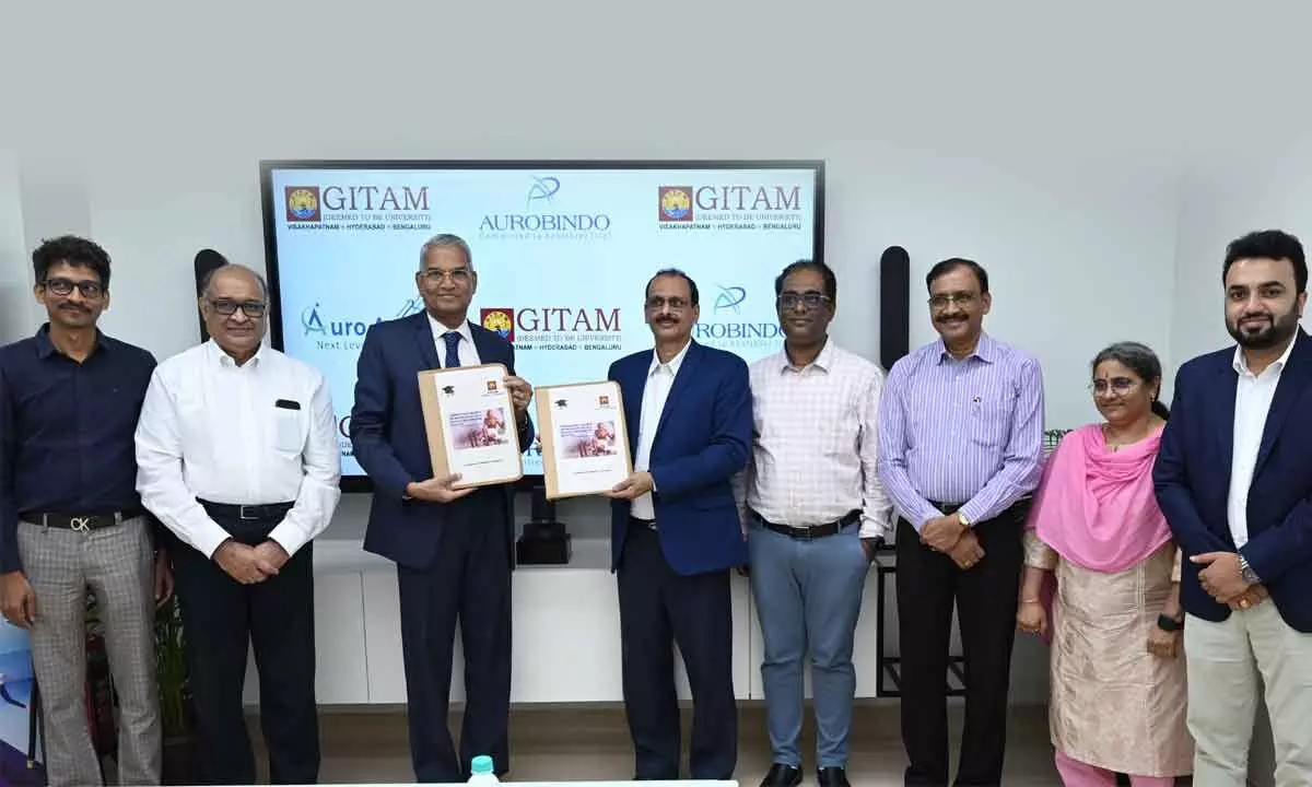 Pro vice-chancellor Y Goutham Rao and Aurobindo Pharma Limited Corporate HR Senior vice president UNB Raju exchanging MoU documents at the campus in Visakhapatnam on Friday