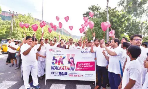 Participants in the walkathon showing heart-shaped balloons to increase awareness on heart health in Tirupati on Sunday.