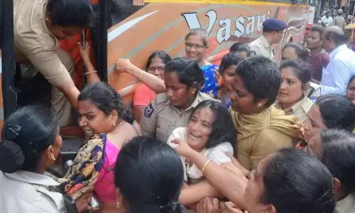 Women police shifting Anganwadi workers and helpers to police station in Vijayawada on Monday
