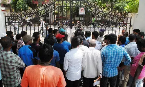 Police personnel preventing the youth, who are trying to lay siege to the Collectorate in Ongole on Monday