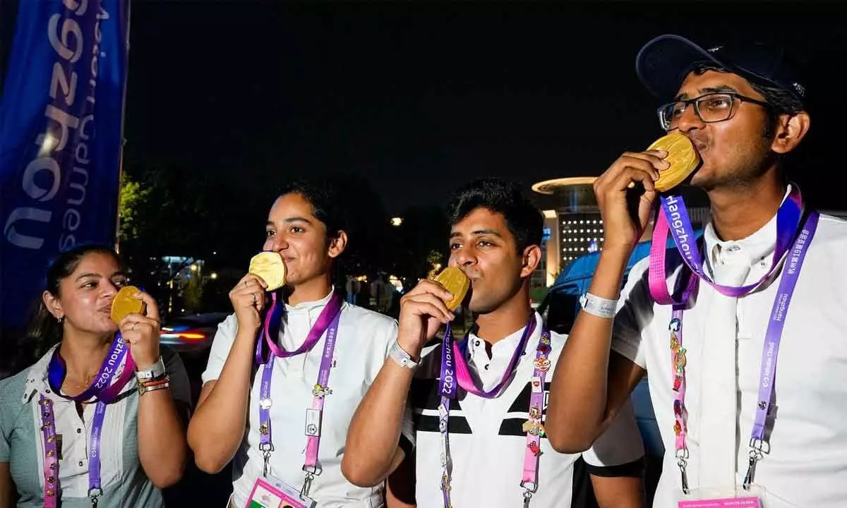 Indias Hriday Vipul Chheda, Anush Agarwalla, Divyakriti Singh and Sudipti Hajela pose for photographs after winning the gold medal in the Eques	trian Dressage Team event at the 19th Asian Games, in Hangzhou, China on Tuesday