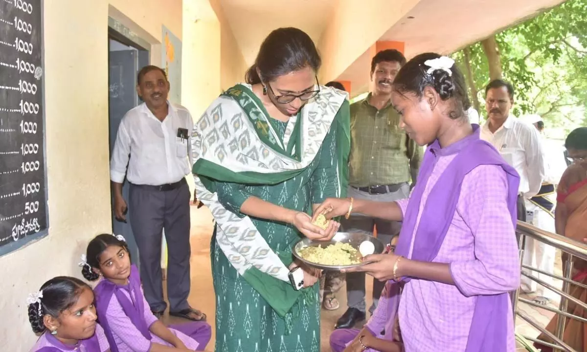 Collector S Nagalakshmi tasting the midday meals in ZPH school in Pittada in Vizianagaram district