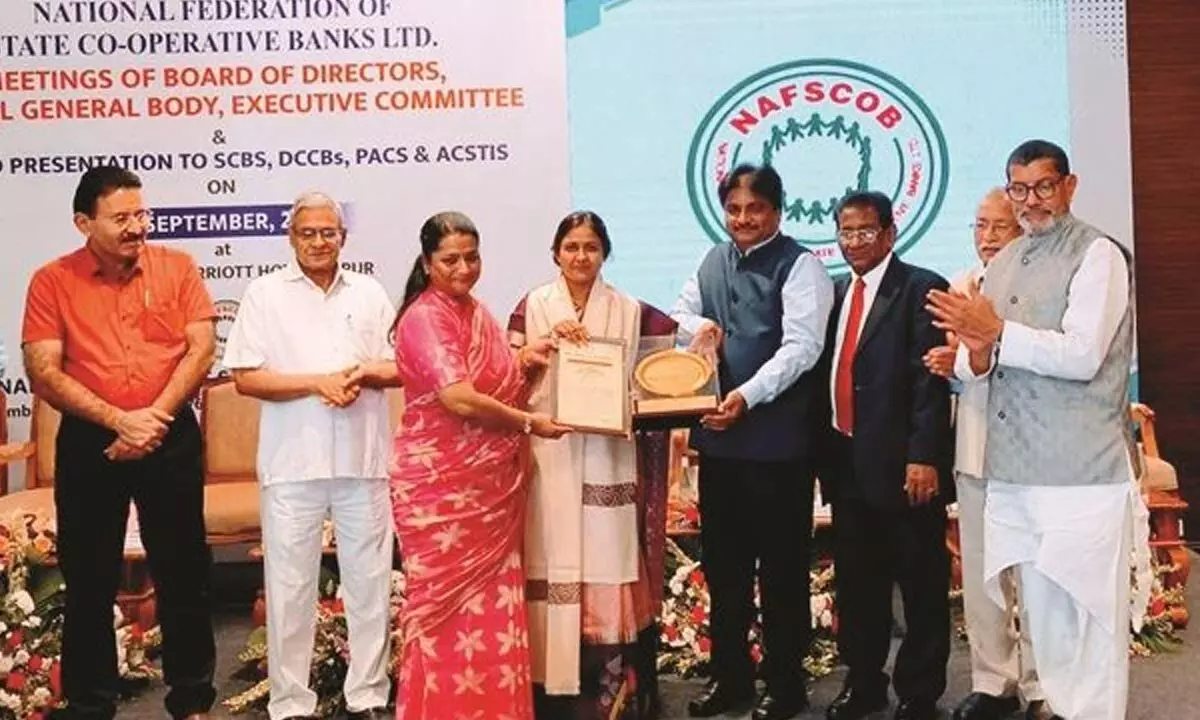 M Jhansi Rani, chairperson and Dr R Shreenath Reddy, managing director of APCOB receive the prizes from NAFSCOB chairman K Ravindra Rao and managing director B Subrahmanyam in Jaipur in Rajasthan on Tuesday