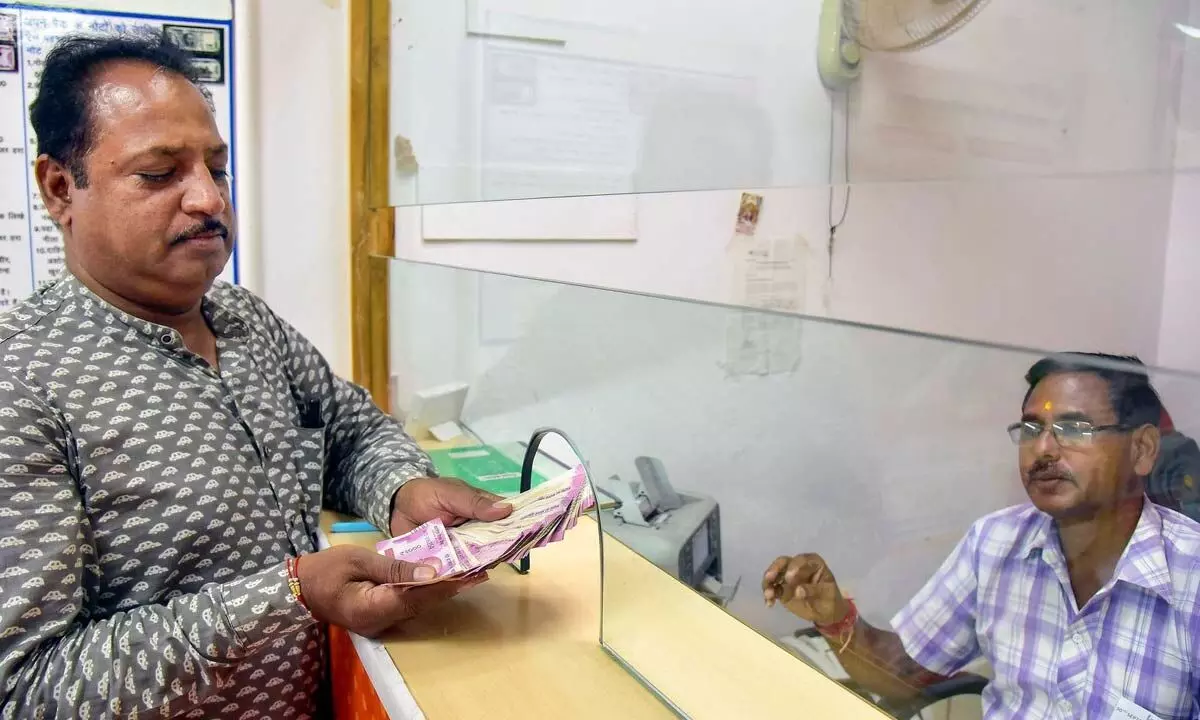 A man deposits Rs 2000 currency notes at a bank on the last day for returning or exchanging the notes, in Bikaner on Saturday