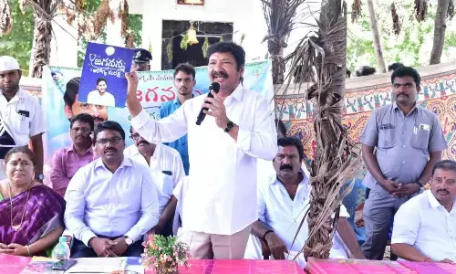 Minister for Housing Jogi Ramesh explaining the Jagananna Aarogya Suraksha  to public in Krishna district on Saturday. Krishna district collector P Rajababu is also seen.