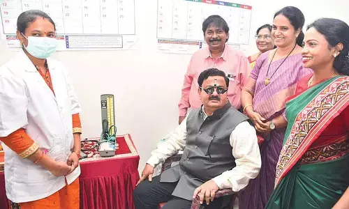 District Collector K Venkataramana Reddy undergoes eye testing at the Aarogya Suraksha health camp in Tirupati on Saturday. Municipal Commissioner D Haritha, DM&HO Dr U Sreehari and others are seen.