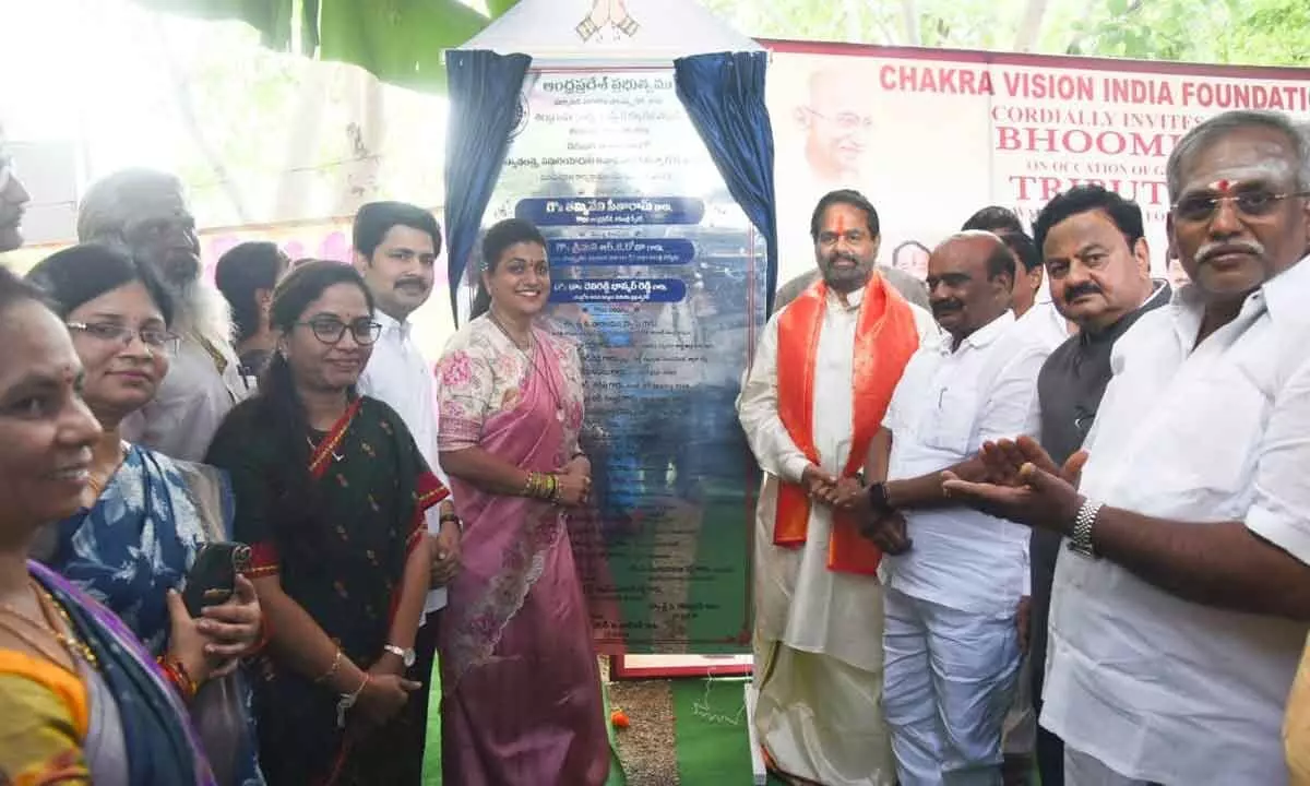 Assembly speaker Thammineni Sitharam, Minister Roja and others unveiling the plaque for the construction of tribute wall at Shilparamam in Tirupati on Monday.