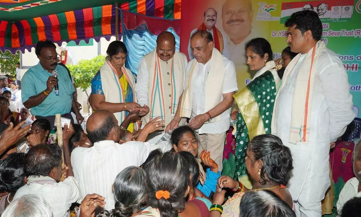 Kasturba Gandhi Kendra Trust chairman Dr PC Rayulu and former Chittoor MP M Gnanendra Reddy distributing clothes to the needy in Tirupati on Monday.
