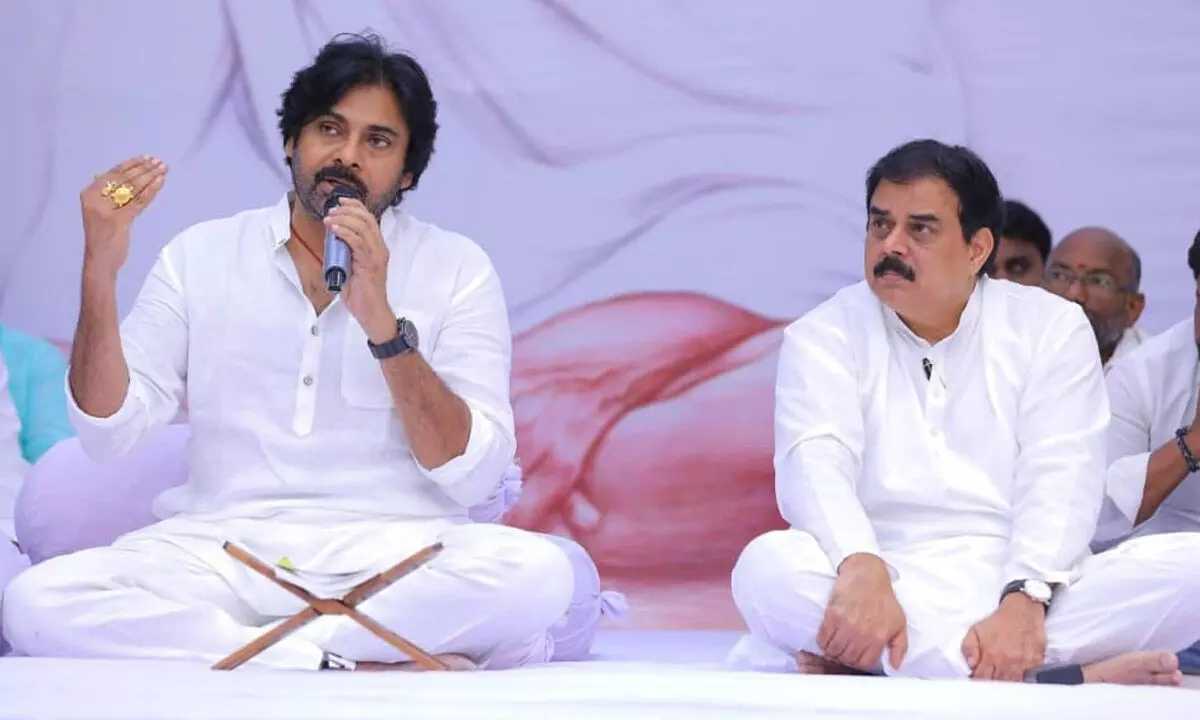 Jana Sena Party president Pawan Kalyan addresses party workers after observing two-hour Mouna Deeksha in Machilipatnam on Monday. Party political affaris commitee chairman Nadendla Manohar is also seen.