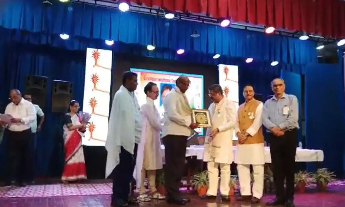 Union Minister of Education and Skill Development Dharmendra Pradhan presenting award to Dr G Sahaya Baskaran of Andhra Loyola College at Lajpat Bhawan in New Delhi