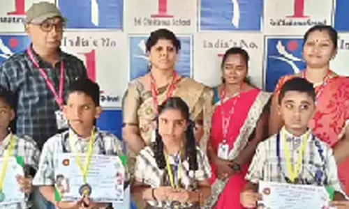 Sri Chaitanya English Medium School Principal Mowla Beebi along with the students, who won medals at karate  competitions, in Nandyal on Tuesday