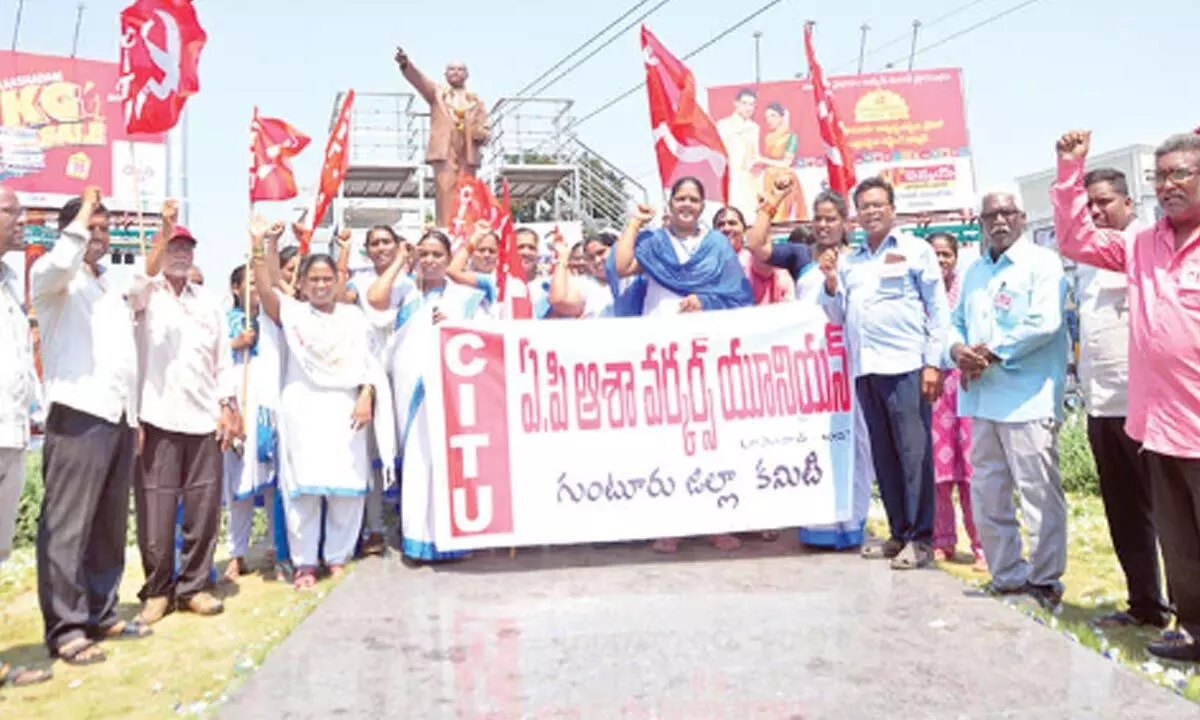 ASHA workers protesting at Ambedkar Statue at Lodge Centre in Guntur city on Saturday