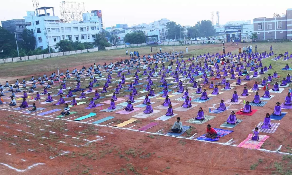 Students from 10 Government and ZP Schools in Ongole mandal performing Surya Namaskar in Ongole on Saturday