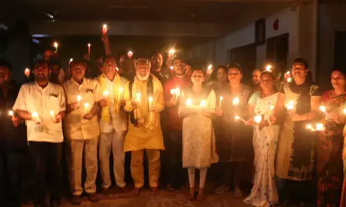 TDP leaders Keerthi, RC Munikrishna Chinababu and others taking part in the candlelight protest in Tirupati on Saturday