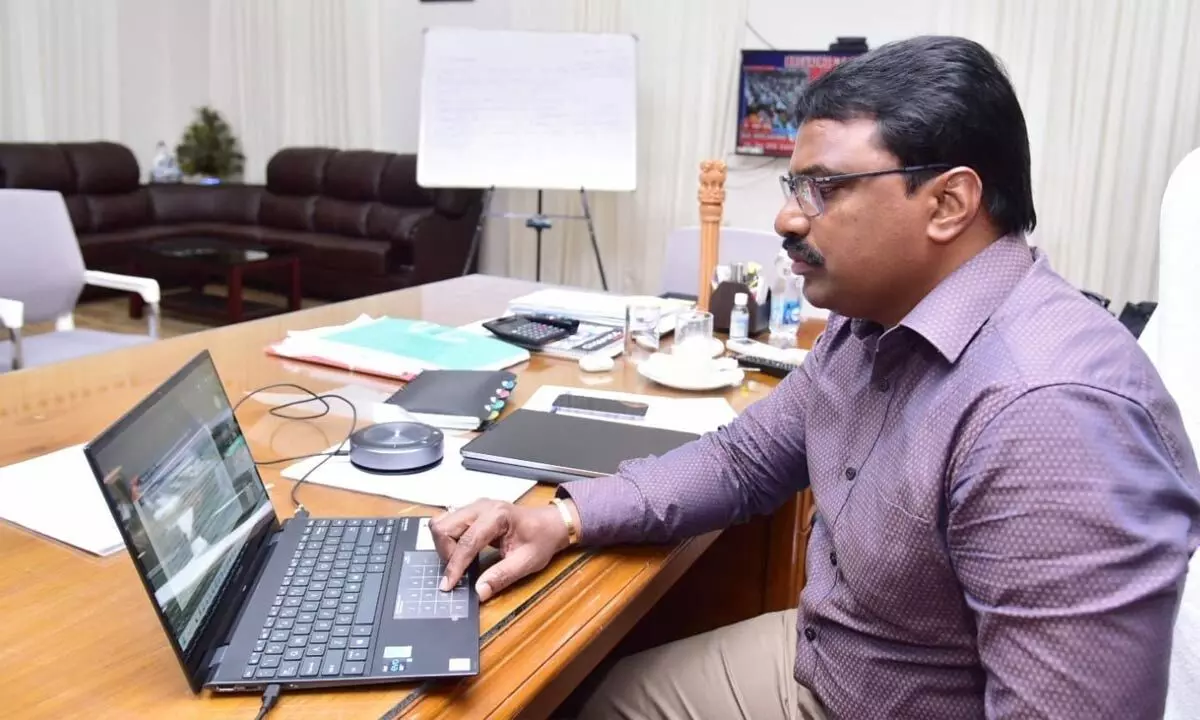 Krishna district Collector P Rajababu participating in a video conference from his office in Machilipatnam on Monday
