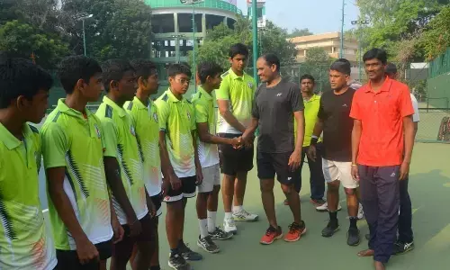 Chief Minister’s security officer Joshi extending his best wishes to AP boys’ team after presenting jerseys to them at the IGMC Stadium in Vijayawada on Saturday